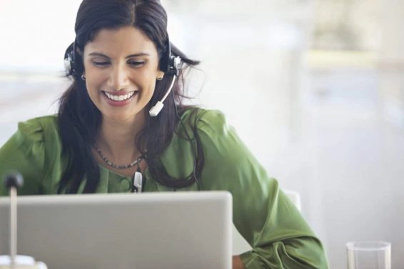 Businesswoman wearing headset at desk