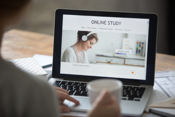 Open laptop on the desk, with online study on screen