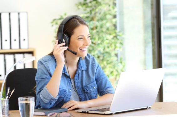 Happy tele operator attending call looking away