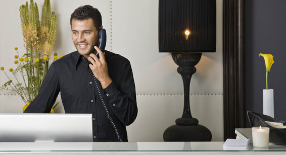 Male receptionist talking on the phone