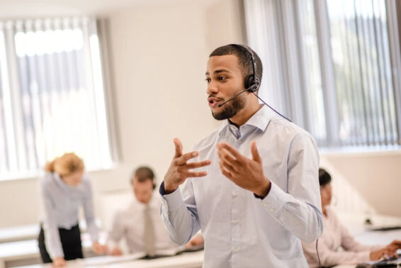 Excited salesperson talking over a bluetooth headset