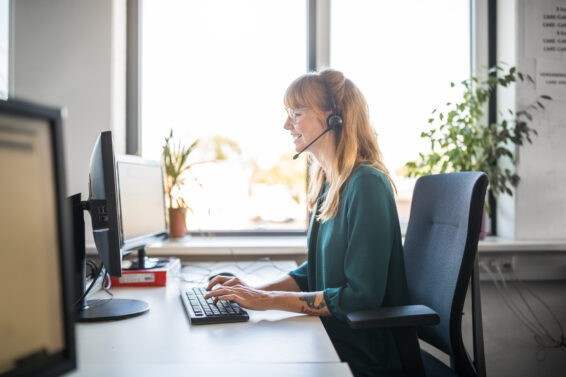 Side view of customer service representative using computer