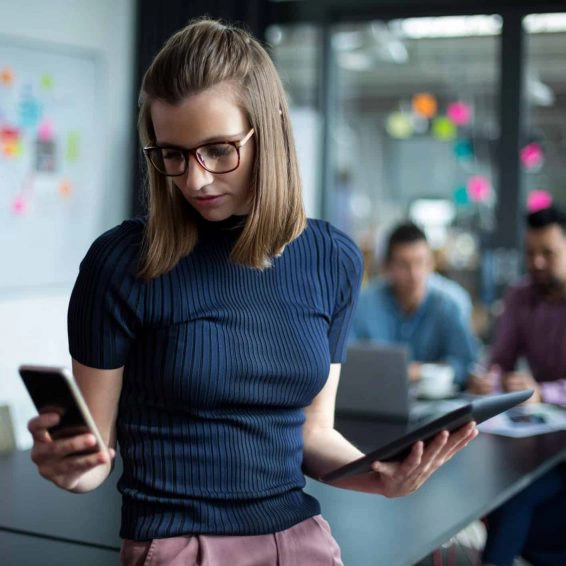 Business executive using mobile phone and digital tablet