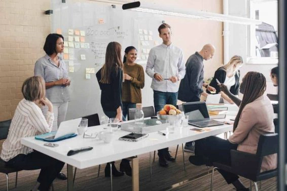 Multi ethnic business coworkers discussing during meeting in board room at office