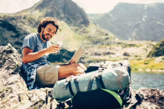 Man texting in the mountain