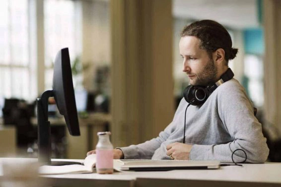 Businessman using desktop pc in creative office