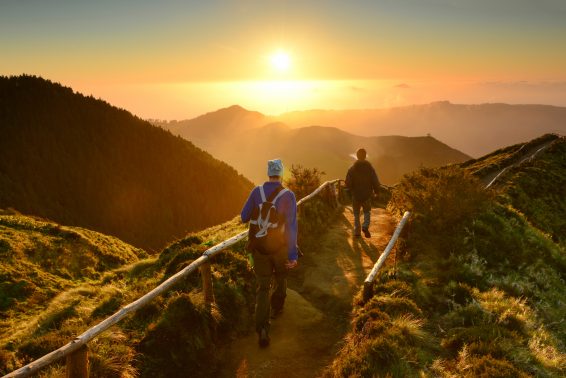 Friends walking at sunset at sete cidades lakes, sao miguel island, azores, atlantic ocean, portugal