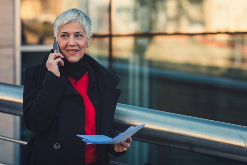 Mature businesswoman working outdoors